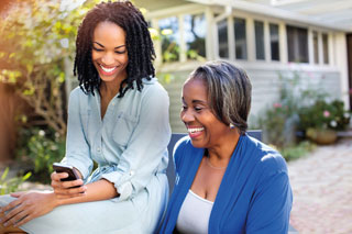 Woman smiling while holding cell phone