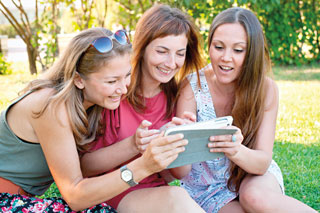 Friends taking a selfie on a cell phone